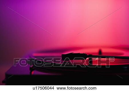 Picture - Close up of turntable on pink background. Fotosearch