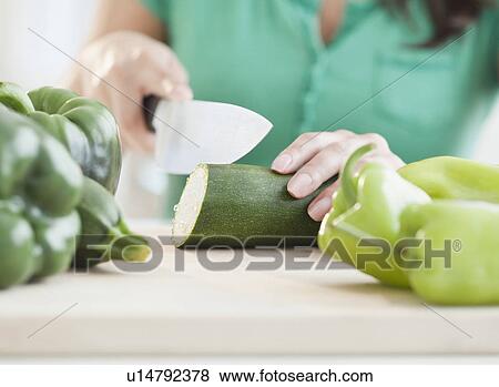 Close up of woman's hand cutting cucumber View Large Photo Image Stock Photo - Close up of woman's hand cutting cucumber. Fotosearch