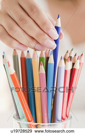 Close up of woman's hand picking colorful pencils View Large Photo Image Stock Photo - Close up of woman's hand picking colorful pencils. Fotosearch