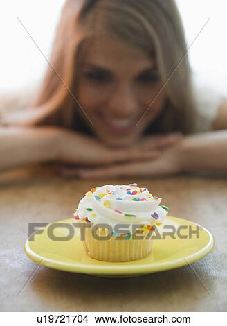 Close up of women looking at cupcake View Large Photo Image Picture - Close up of women looking at cupcake. Fotosearch