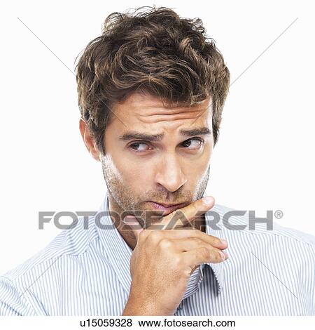 Close-up portrait of confused business man with had on chin against white background View Large Photo Image Stock Photo - Close-up portrait of confused business man with had on chin against white background. Fotosearch