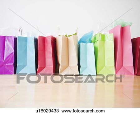 Stock Image - Colorful shopping bags standing in row. Fotosearch