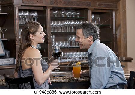 Stock Photograph - Couple enjoying in bar. Fotosearch