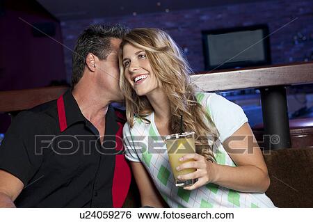 Stock Photograph - Couple having drink in bar. Fotosearch
