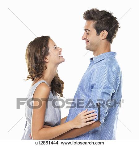 Picture - Couple in love looking at each other and smiling. Fotosearch