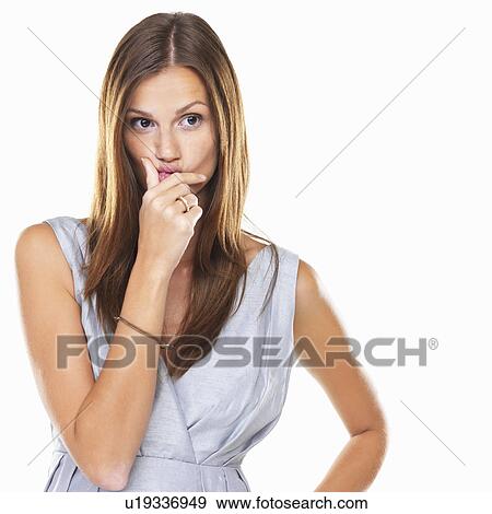 Cute thoughtful woman pinching her lips and looking away View Large Photo Image Stock Photo - Cute thoughtful woman pinching her lips and looking away. Fotosearch
