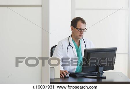 Stock Image - Doctor using computer. Fotosearch