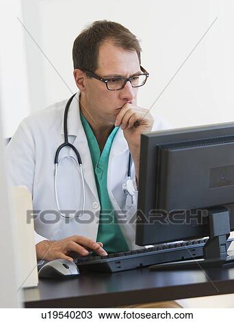 Doctor using computer View Large Photo Image Stock Image - Doctor using computer. Fotosearch