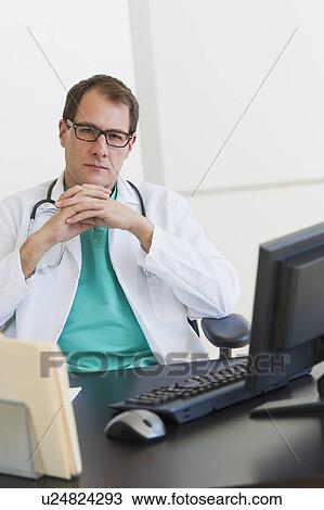 Stock Image - Doctor using computer. Fotosearch