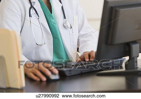 Stock Image - Doctor using computer. Fotosearch