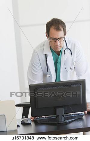 Stock Photo - Doctor using computer. Fotosearch