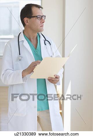 Doctor writing in clipboard View Large Photo Image Stock Photo - Doctor writing in clipboard. Fotosearch