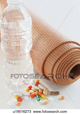 Exercise mat, water bottle and colorful pills, studio shot View Large Photo Image Stock Image - Exercise mat, water bottle and colorful pills, studio shot. Fotosearch