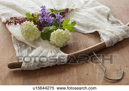 Stock Photography - Flowers on dress with coat hanger. Fotosearch