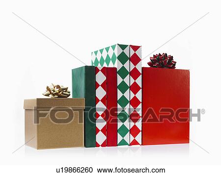 Stock Image - Four boxes with ribbons, studio shot. Fotosearch
