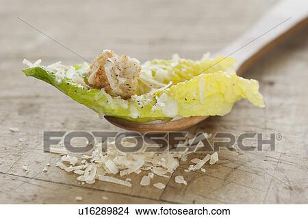 Fresh caesar salad on wooden spoon View Large Photo Image Picture - Fresh caesar salad on wooden spoon. Fotosearch