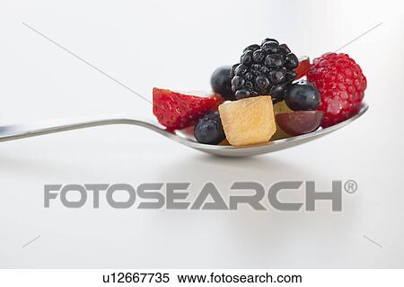 Stock Photography - Fresh fruit salad on spoon. Fotosearch