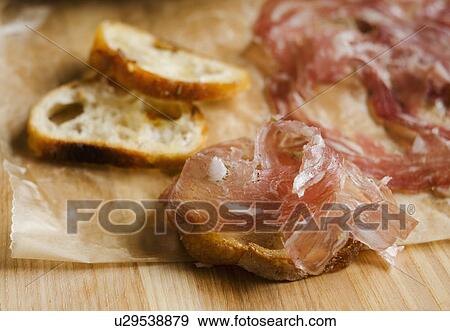 Fresh prosciutto ham with bread View Large Photo Image Stock Photo - Fresh prosciutto ham with bread. Fotosearch