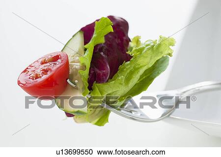 Fresh salad on fork View Large Photo Image Stock Image - Fresh salad on fork. Fotosearch