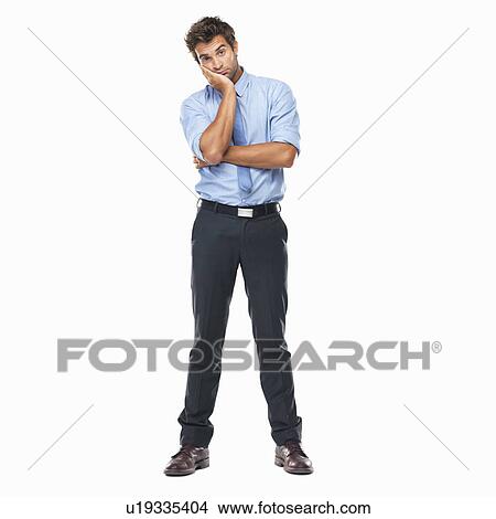 Full length of bored business man standing with hand on face against white background View Large Photo Image Picture - Full length of bored business man standing with hand on face against white background. Fotosearch