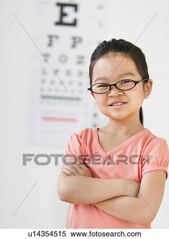 Stock Photography - Girl (6-7) at eye exam. Fotosearch