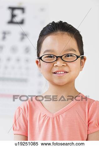 Girl (6-7) at eye exam View Large Photo Image Stock Photography - Girl (6-7) at eye exam. Fotosearch