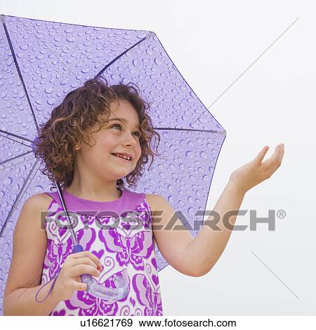 Stock Photo - Girl (6-7) with umbrella. Fotosearch