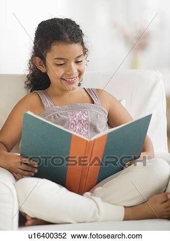 Girl (8-9) reading book View Large Photo Image Stock Image - Girl (8-9) reading book. Fotosearch