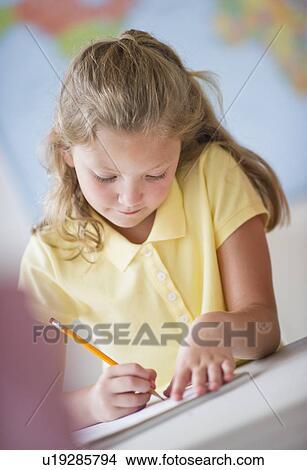 Picture - Girl (8-9) taking exam. Fotosearch