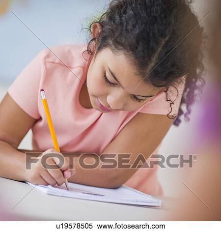Stock Photography - Girl (8-9) taking exam. Fotosearch