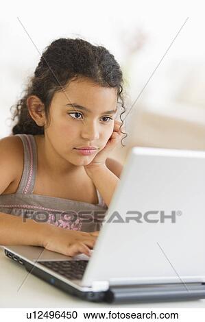 Girl (8-9) using laptop View Large Photo Image Stock Image - Girl (8-9) using laptop. Fotosearch