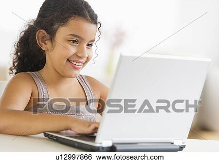 Girl (8-9) using laptop View Large Photo Image Stock Photograph - Girl (8-9) using laptop. Fotosearch