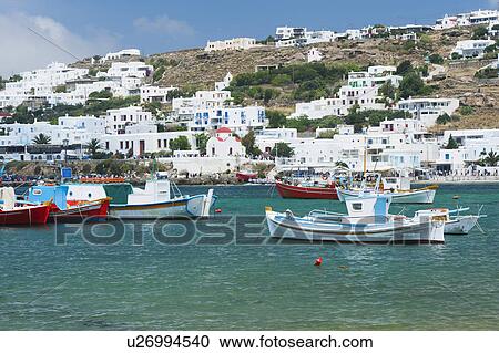 Stock Image - Greece, Cyclades Islands, Mykonos, Fishing boats in harbor. Fotosearch