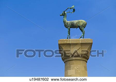 Stock Image - Greece, Rhodes, Deer statue in Mandraki Harbor. Fotosearch
