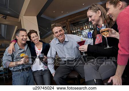 Group of people enjoying apres ski drink in bar View Large Photo Image Picture - Group of people enjoying apres ski drink in bar. Fotosearch