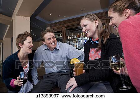 Group of people enjoying apres ski drink in bar View Large Photo Image Stock Photo - Group of people enjoying apres ski drink in bar. Fotosearch