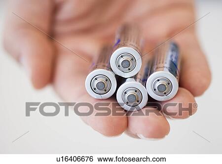 Hand holding batteries View Large Photo Image Stock Photograph - Hand holding batteries. Fotosearch