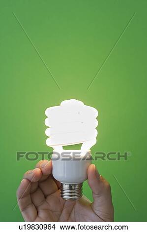 Hand holding lightbulb View Large Photo Image Picture - Hand holding lightbulb. Fotosearch
