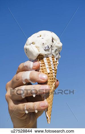Hand holding melting ice cream View Large Photo Image Picture - Hand holding melting ice cream. Fotosearch
