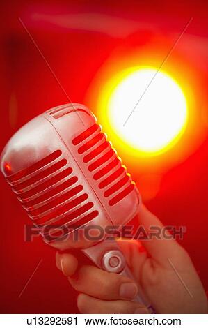 Hand holding microphone View Large Photo Image Stock Image - Hand holding microphone. Fotosearch