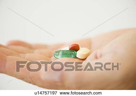 Hand holding pills View Large Photo Image Stock Photo - Hand holding pills. Fotosearch