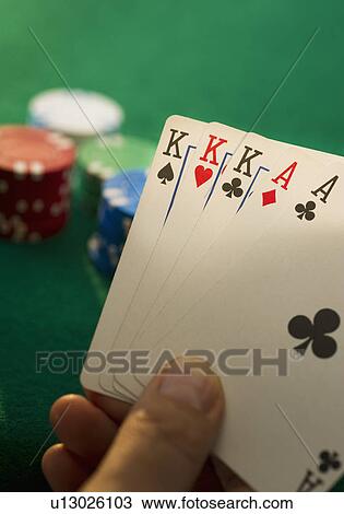 Stock Image - Hand holding playing cards. Fotosearch