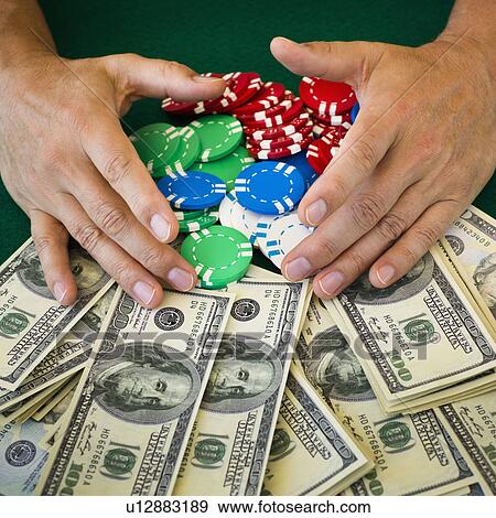 Hands grabbing gambling chips and money View Large Photo Image Stock Photo - Hands grabbing gambling chips and money. Fotosearch