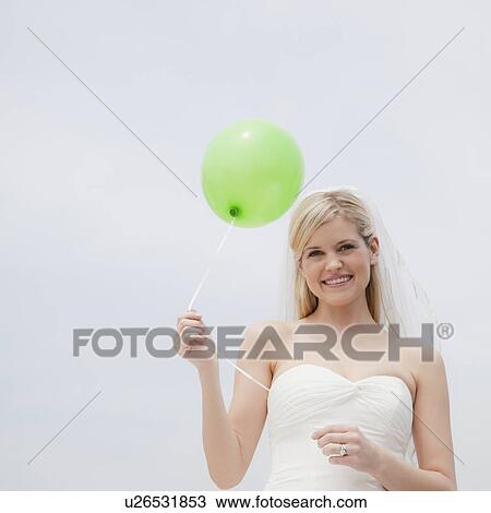 Happy bride holding green balloon View Large Photo Image Stock Image - Happy bride holding green balloon. Fotosearch