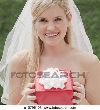 Happy bride holding red box View Large Photo Image Stock Image - Happy bride holding red box. Fotosearch