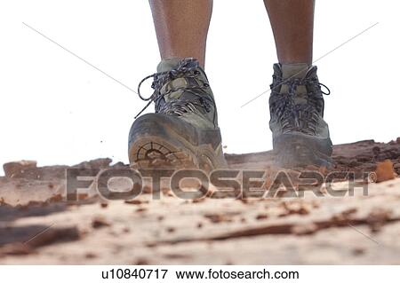 Stock Photo - Hiking boots moving across rocky surface. Fotosearch