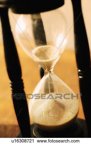 Stock Image - Hourglass with pouring sand. Fotosearch