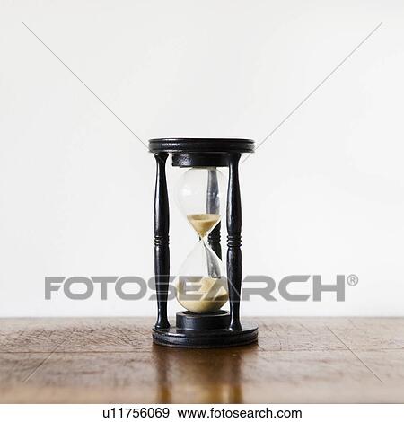Hourglass with pouring sand View Large Photo Image Stock Photo - Hourglass with pouring sand. Fotosearch