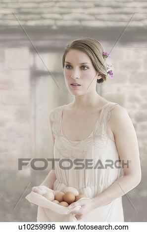 Ireland, Young woman carrying basket of eggs View Large Photo Image Stock Photograph - Ireland, Young woman carrying basket of eggs. Fotosearch