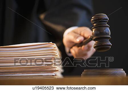 Stock Image - Judge holding gavel, close-up. Fotosearch